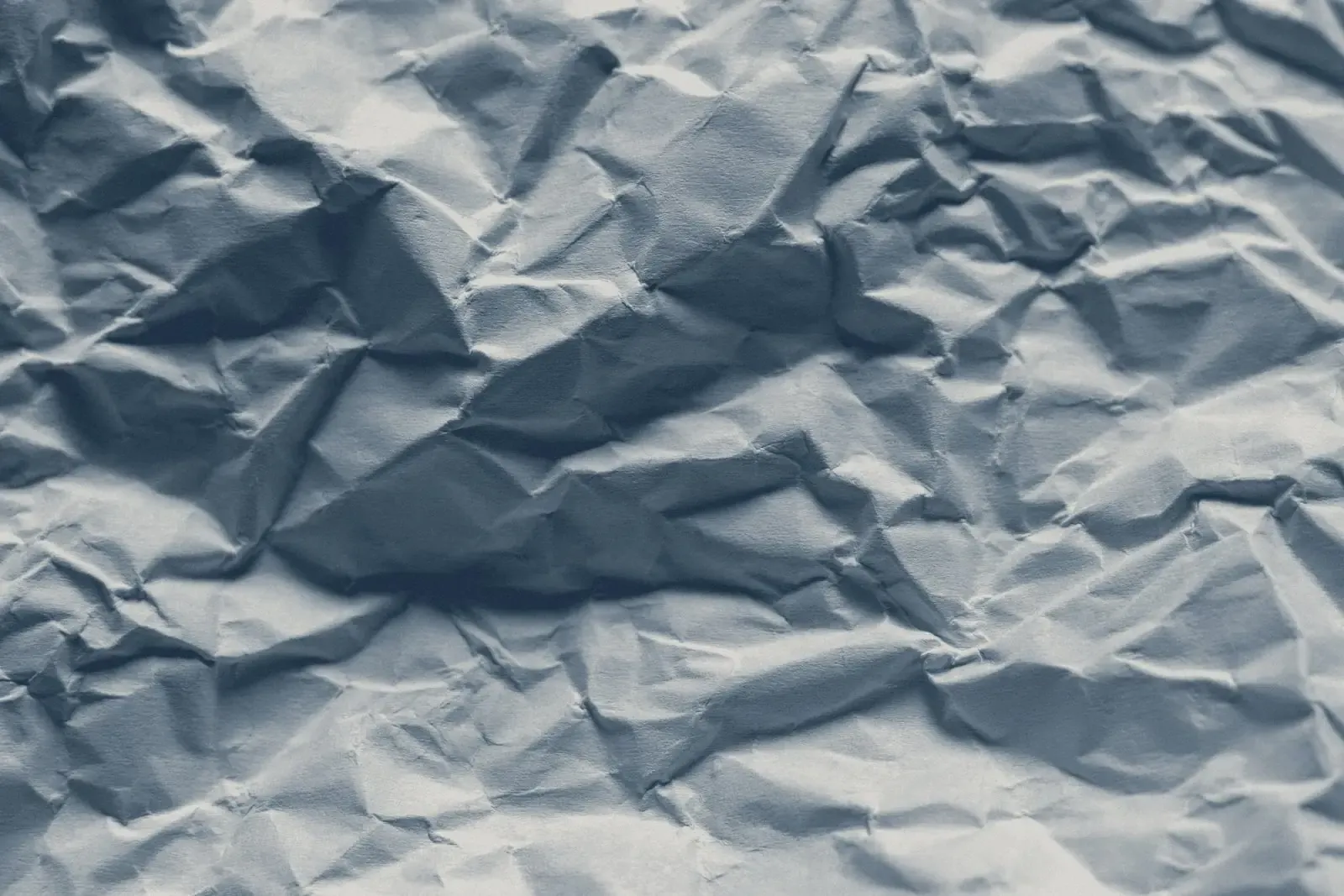 Crumpled paper, in muted navy tones